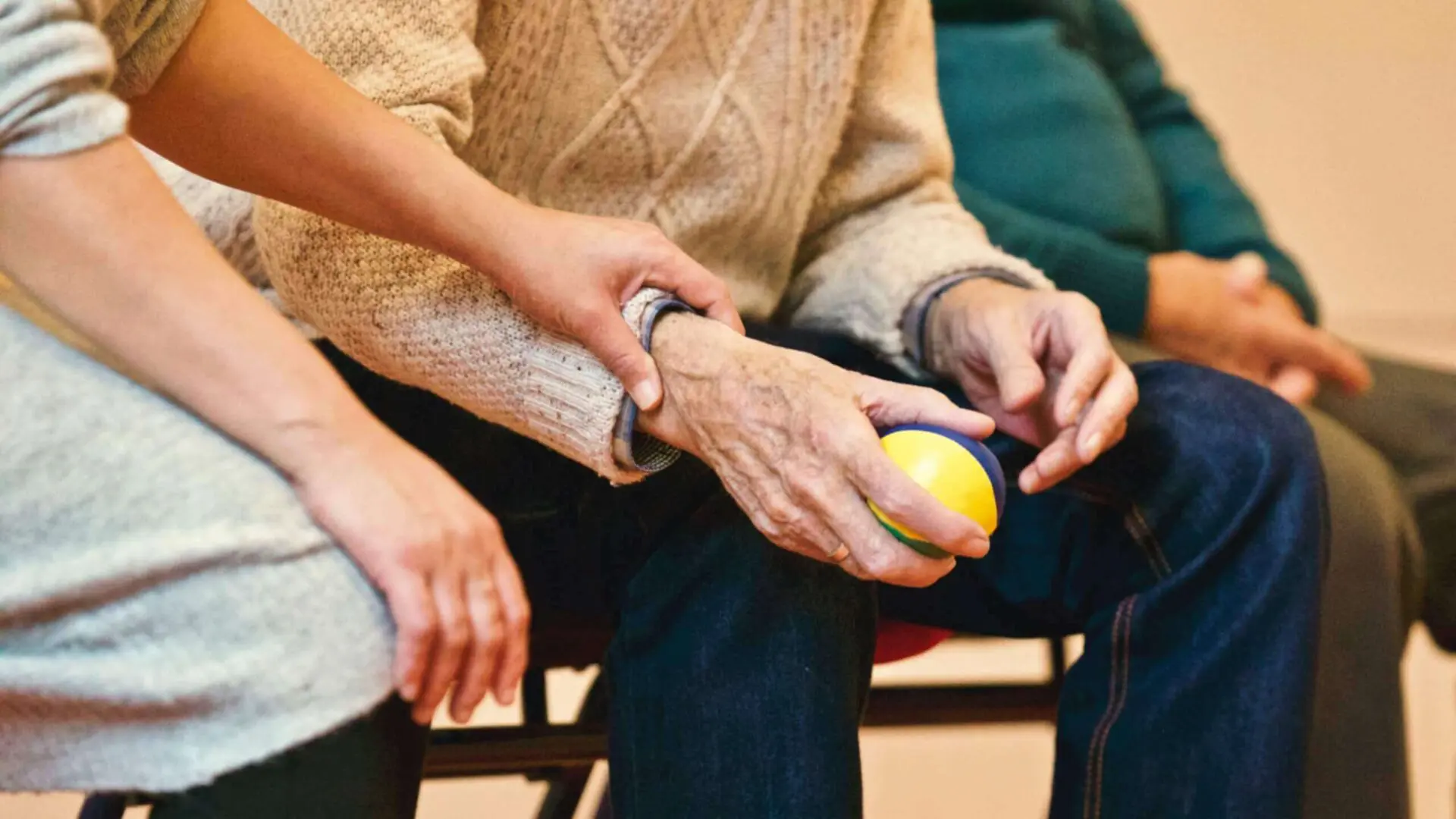 Old man holding ball in hand