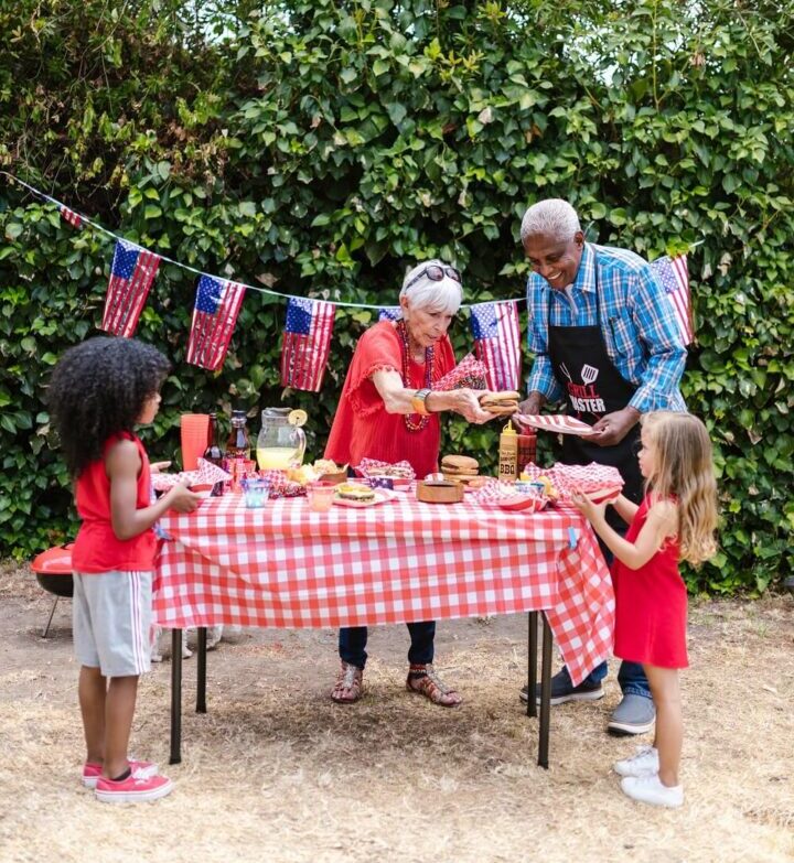 Old Couple having meal in park with kids